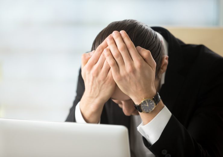 Businessman shocked because of company bankruptcy