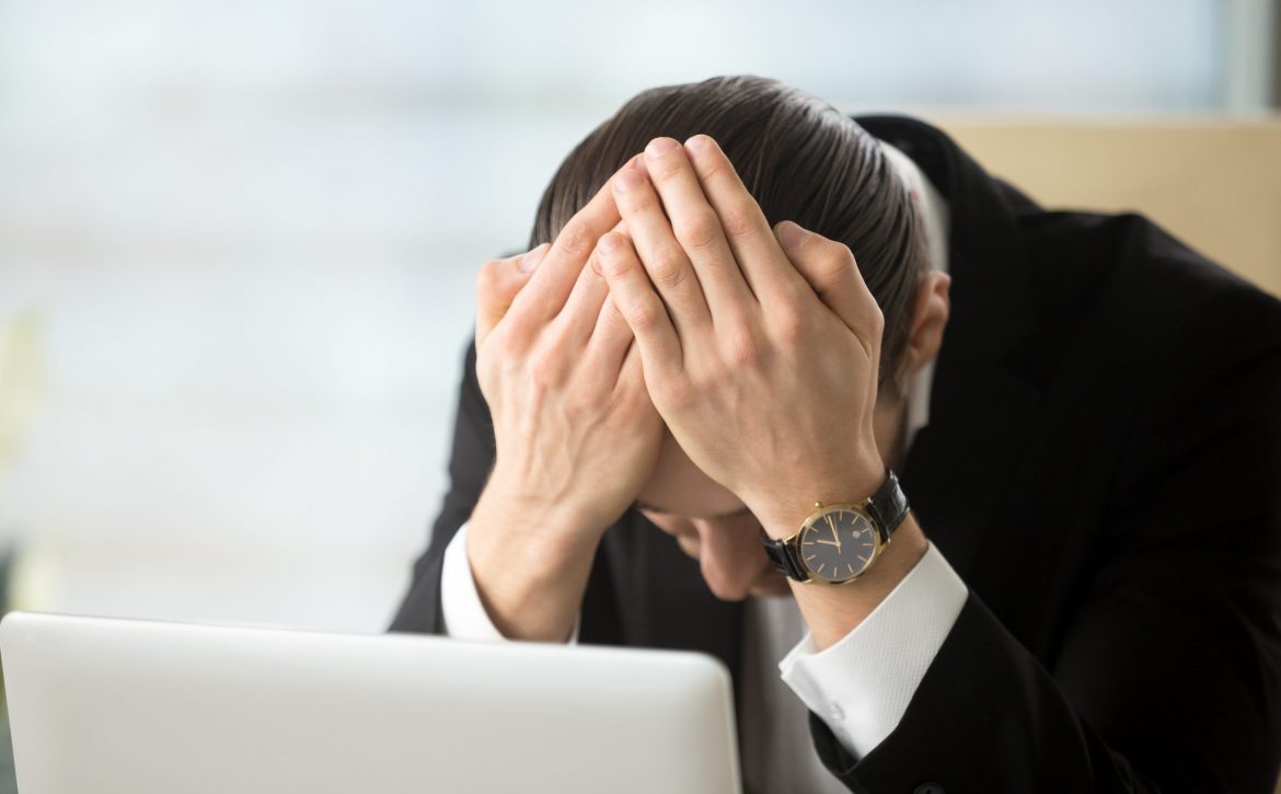 Businessman shocked because of company bankruptcy
